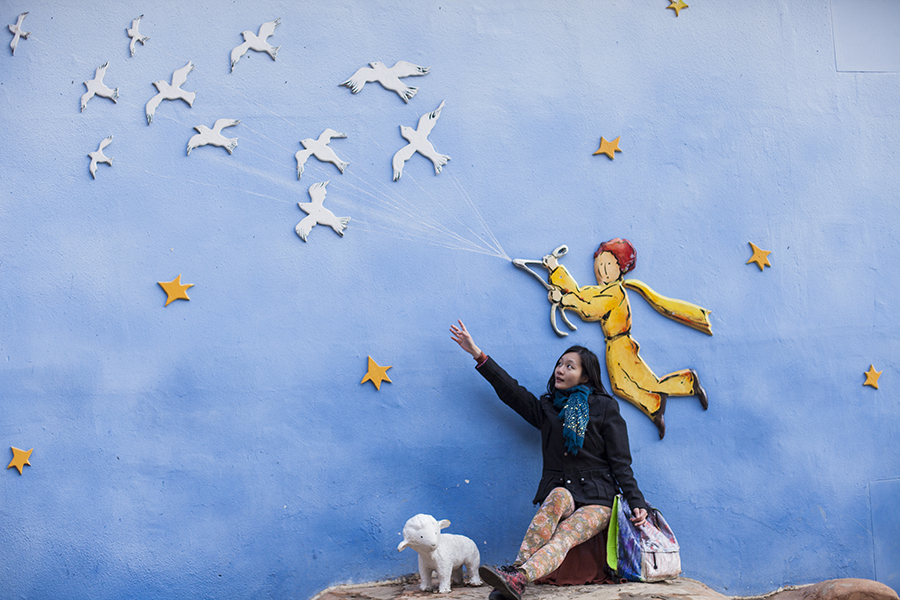 Ren posing against a 3d mural of the little prince flying off at Le Petit France, Gapyeong, South Korea.