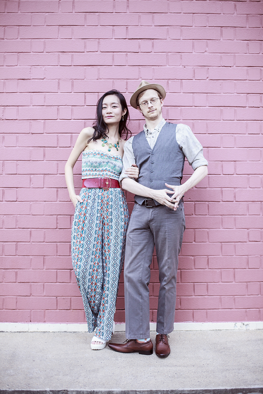 Couple outfit photo of Ren and Ottie featuring American Rag jumpsuit, Accessorize red belt, Topman grey vest, Topman grey slacks, Black Hammer brown loafers.