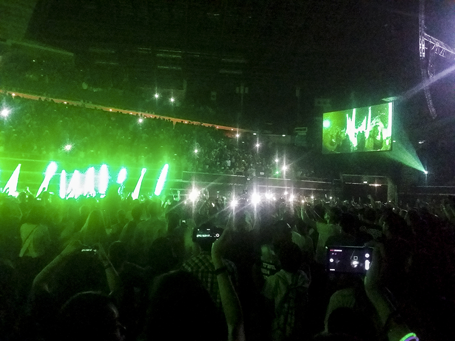 The Script entering the stage with green flare lights.