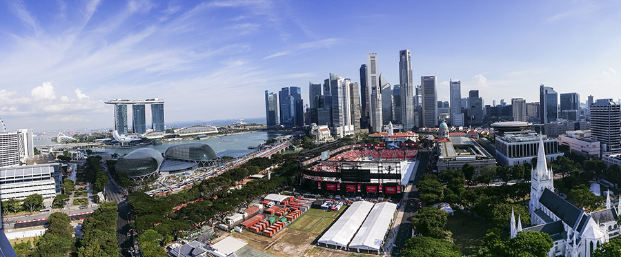 Panoramic view of the downtown central business district of Singapore, Marina Bay Sands, the Padang during National Day Parade rehearsals, the Esplanade, and the Singapore River in the afternoon.