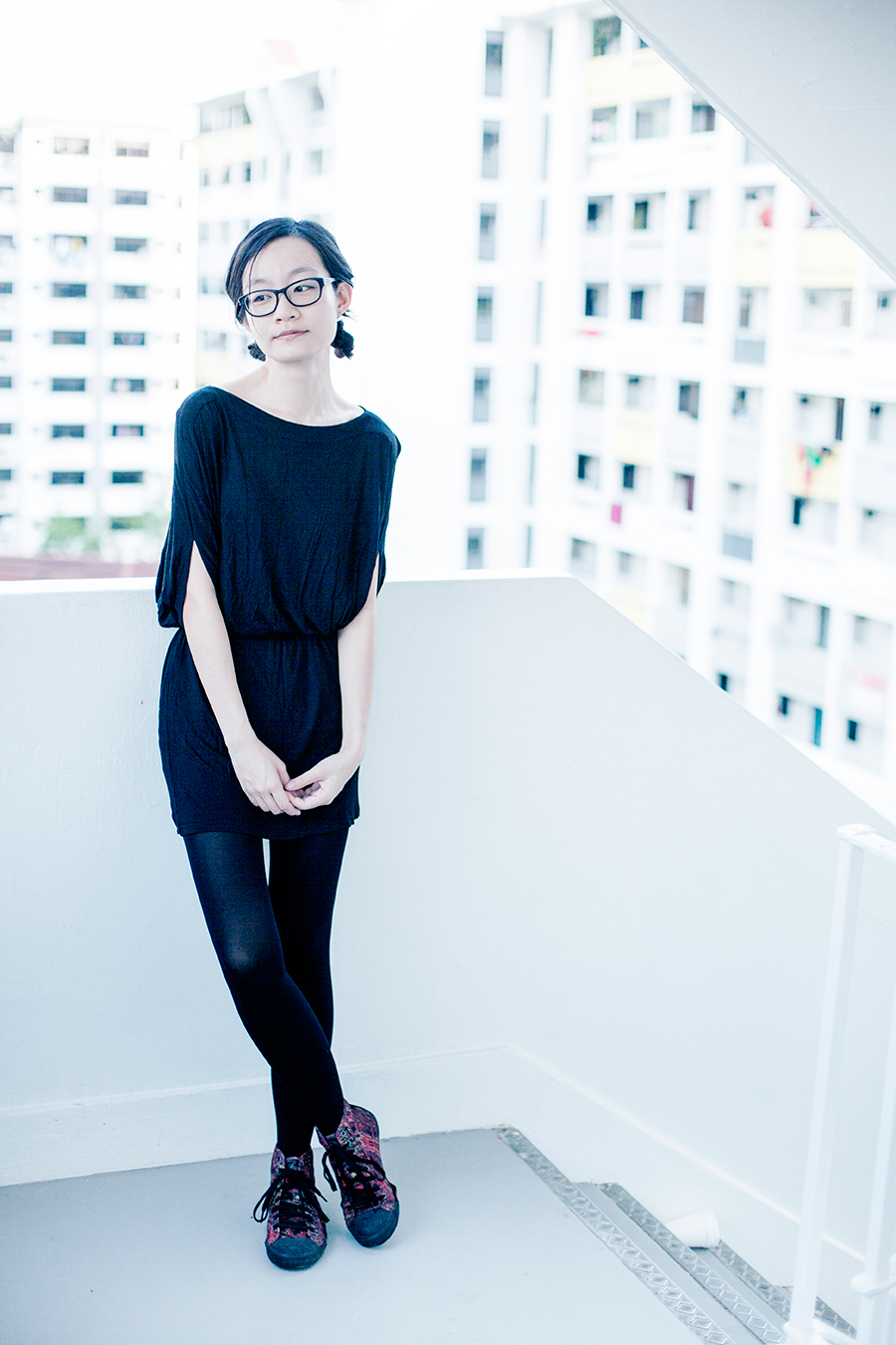 Monochroma outfit: M)phosis black tunic dress, Alexander McQueen x Puma high top sneakers, Gap black frame glasses.
