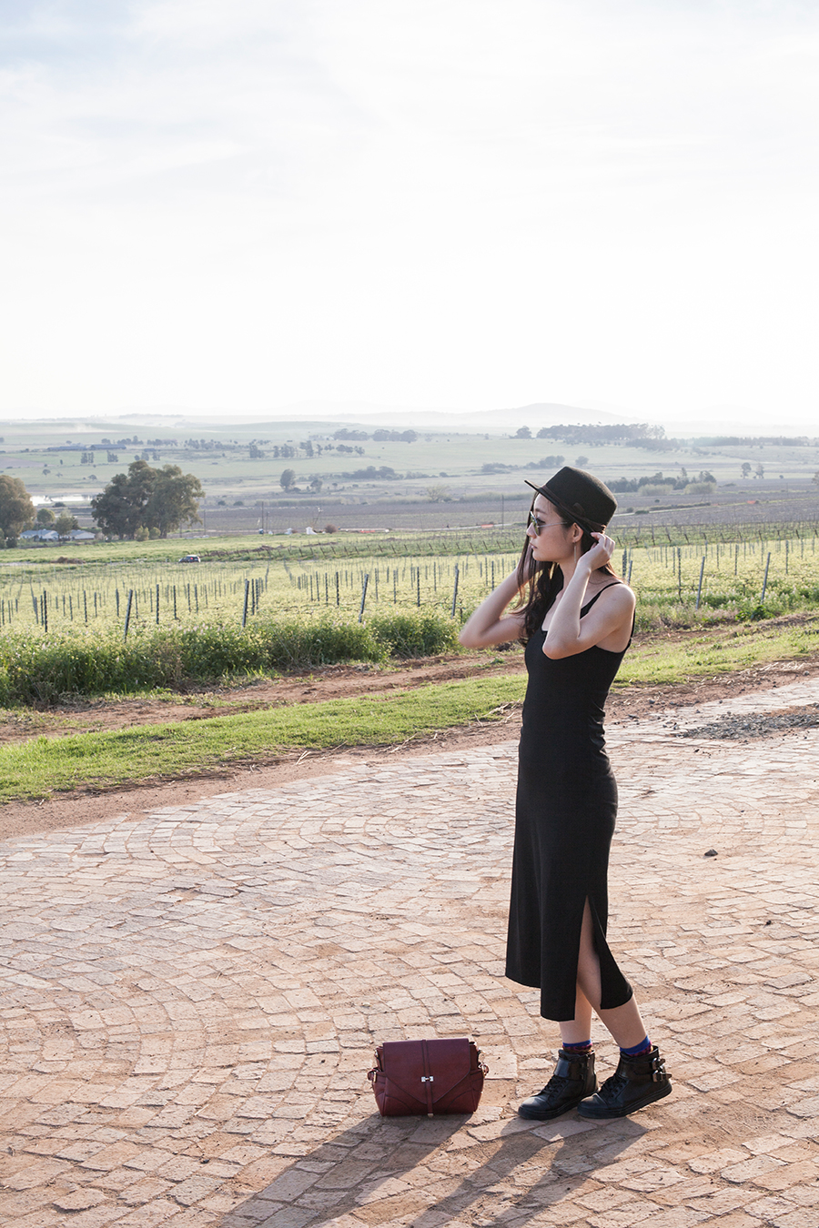 Outfit at Fairview Wine and Cheese, South Africa: Newdress black side slit dress, Dressin silver mirror sunglasses, Dressgal red satchel handbag, Stance warrior crew socks via Shopbop, Zalora PU black high top sneakers, Taobao black hat.
