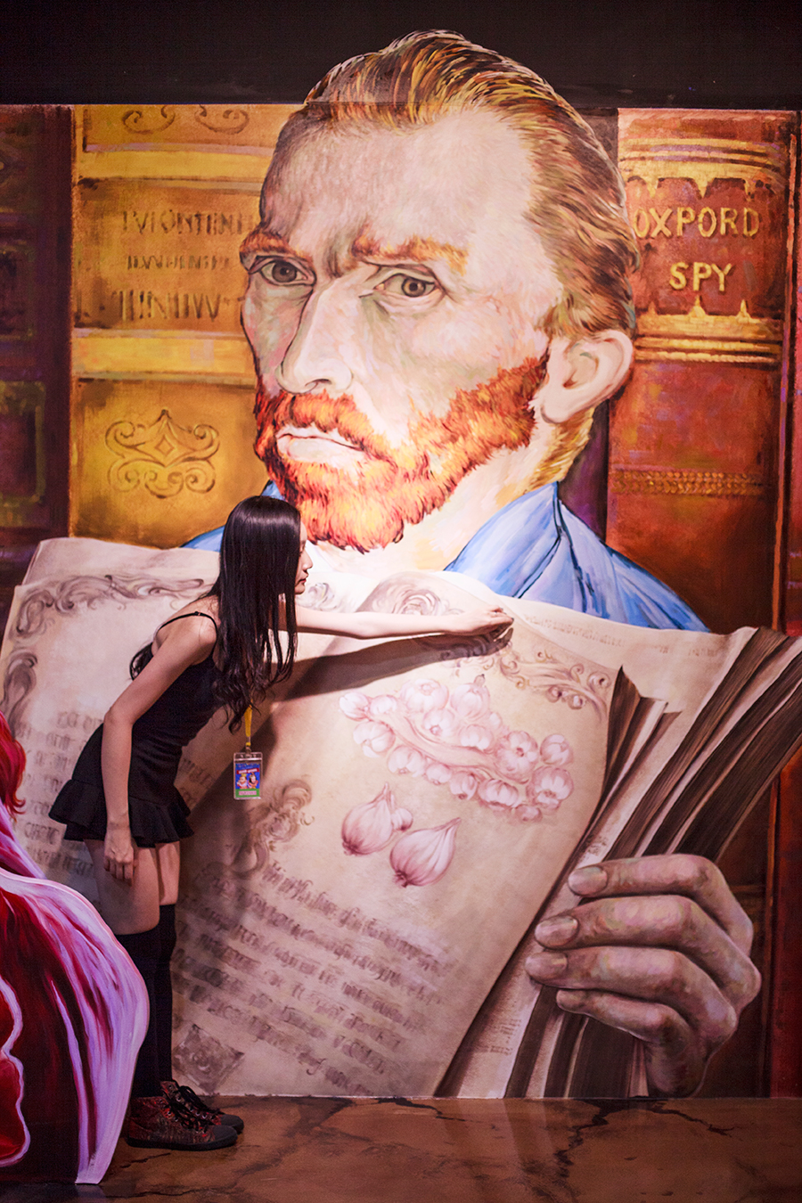 Turning a page of Vincent Van Gogh's book trompe-l'œil at the Trick Eye Museum Renewal Event in Singapore, Resorts World Sentosa.