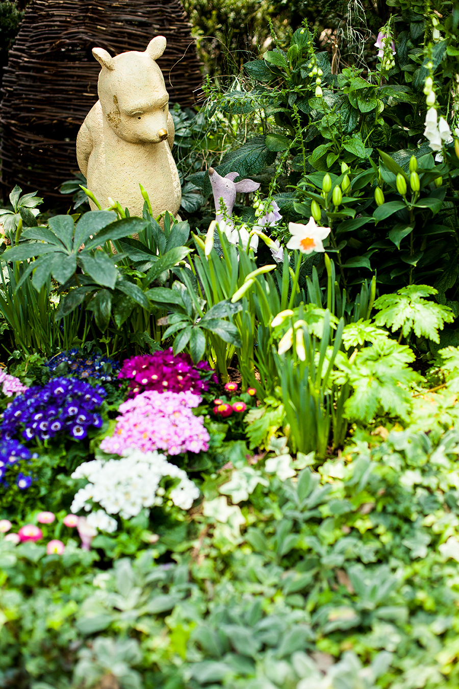 Winnie the Pooh and Piglet among flowers at the Flower Dome at Gardens by the Bay, Singapore.