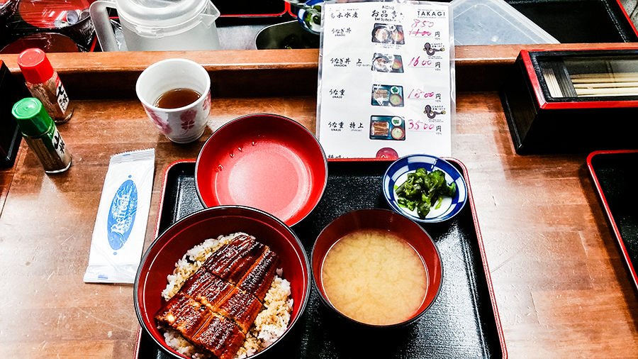 Unagi don and menu at Takagi Suisan eel restaurant, Osaka, Japan.