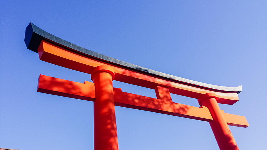 Torii against blue sky at Fushimi Inari, Kyoto Japan.