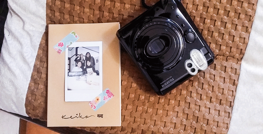 Animated gif of our parting gift to Keiko-mama: a MUJI notebook with farewell notes and a Fujifilm Instax snapshot together.