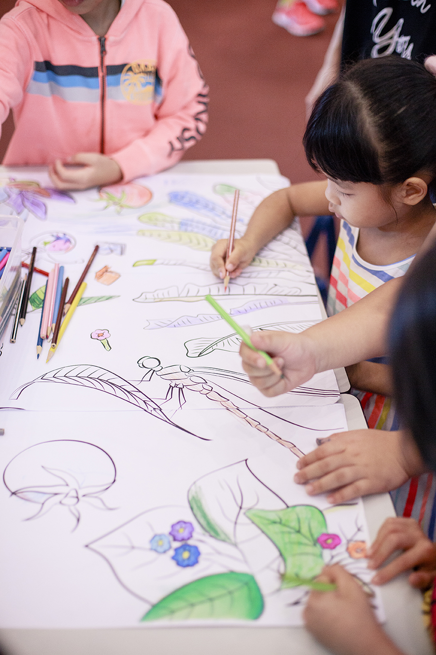 Kids colouring at the Floral Cosmos Colouring Booth at #FabricMuralLaunchParty