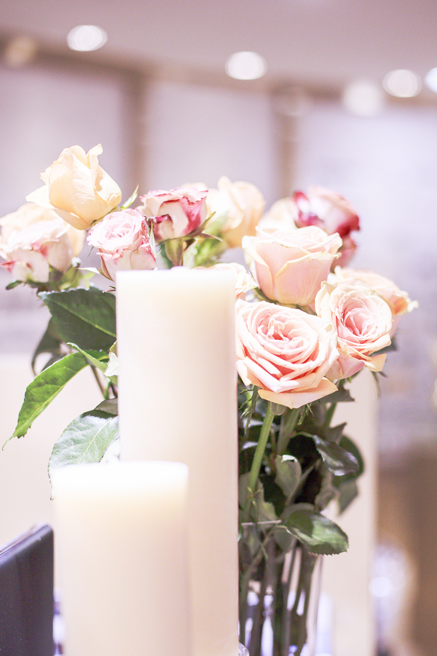 Candles and pastel roses at the Her World x Optic Butler Event, Paragon, Singapore.