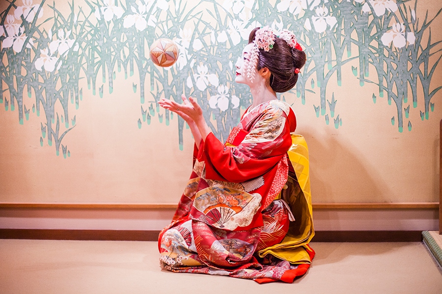 Maiko playing with an ornamental ball at Maica, Gion Kyoto Japan.