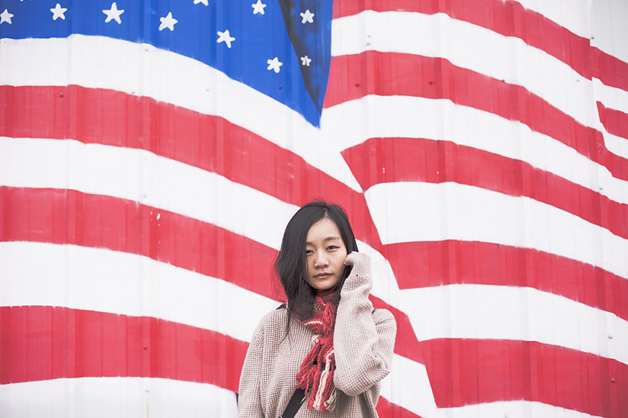 In front of the US flag: Fox multicolor scarf, boyfriend sweater.