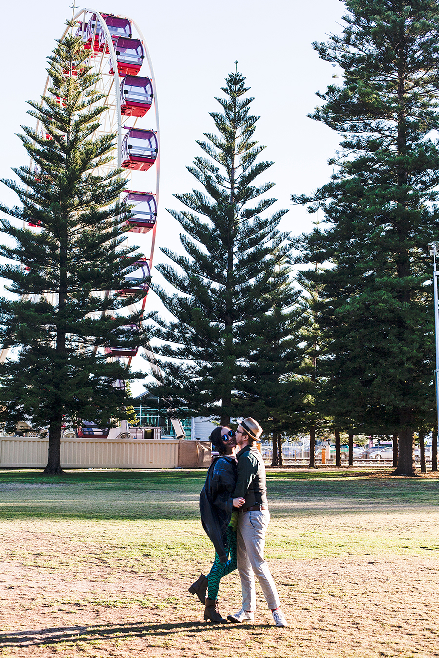 Couple photo in front of a ferris wheel Fremantle Perth Australia.