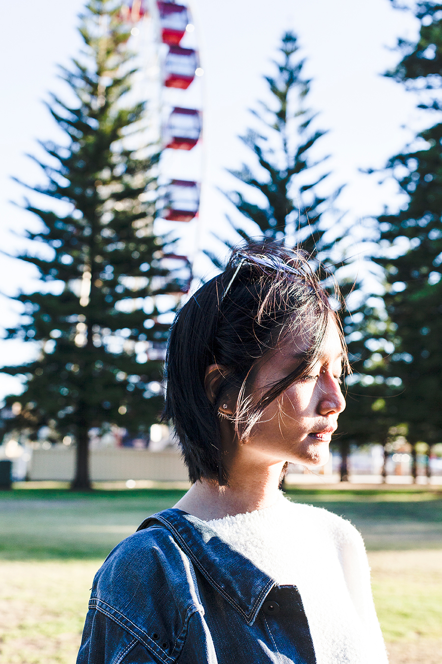 Windswept portrait in front of a ferris wheel in Fremantle Australia.