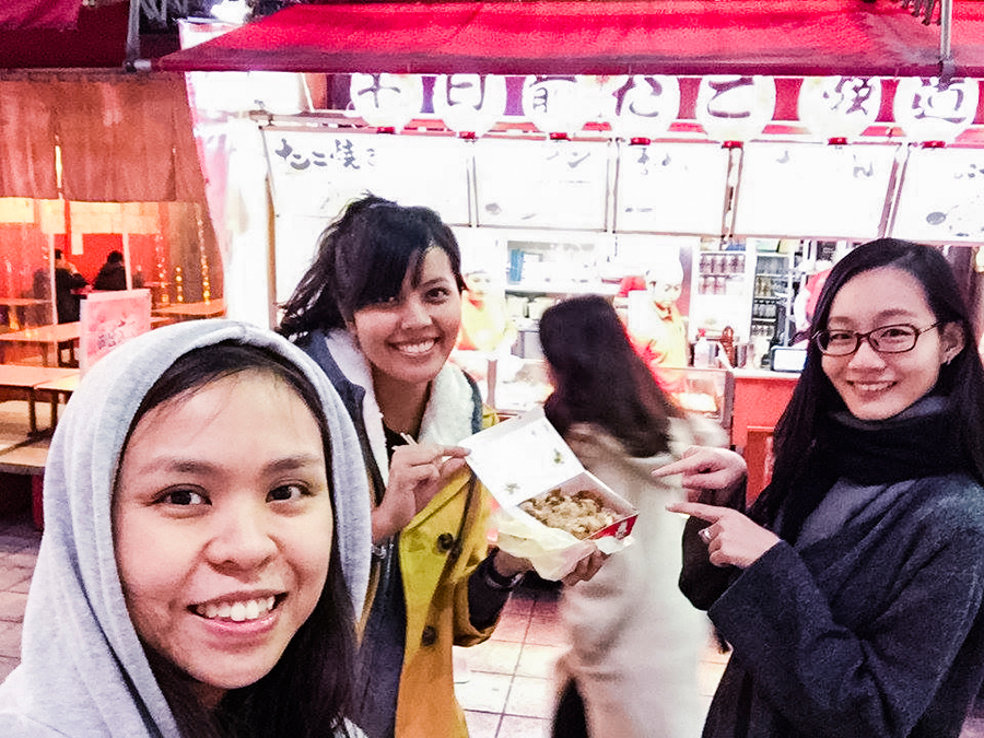 Posing with our Takoyaki outside the stall in Osaka, Japan. Photo by Ruru.