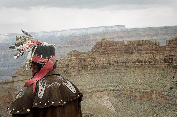 View of the Grand Canyon and of a tribal native.