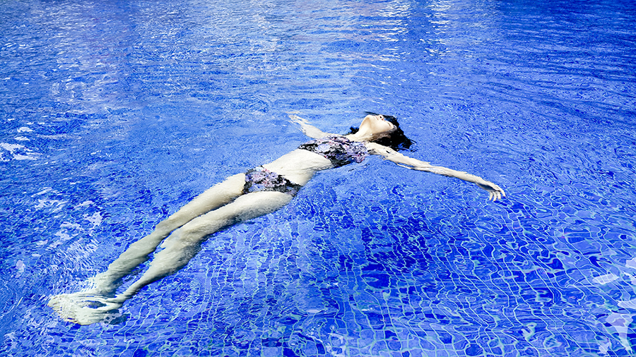 Floating in a swimming pool wearing Funfit floral bikini.