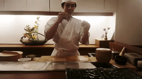 Chef Kyohei demonstrating how to extract the snail out of its shell in Makoto Sushi.